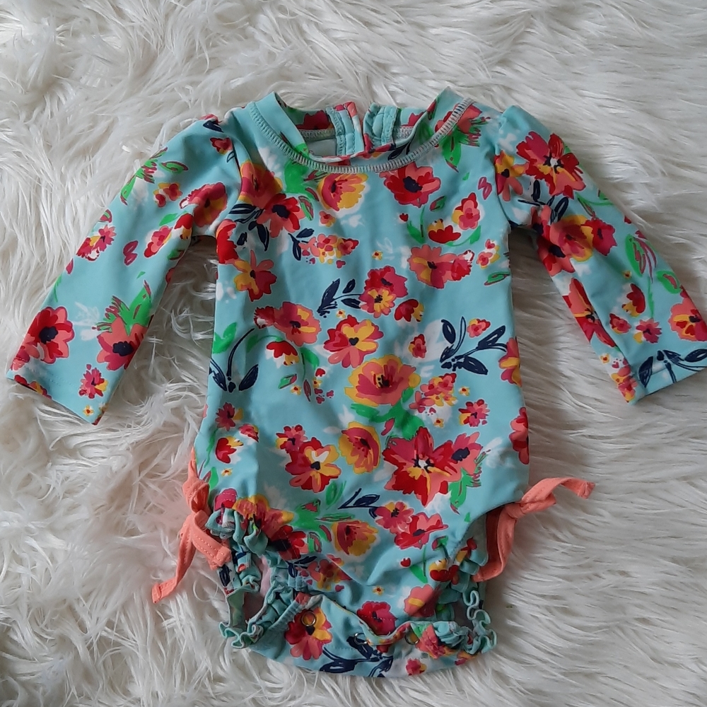 Ruffle butts brand swim suit for baby girl.